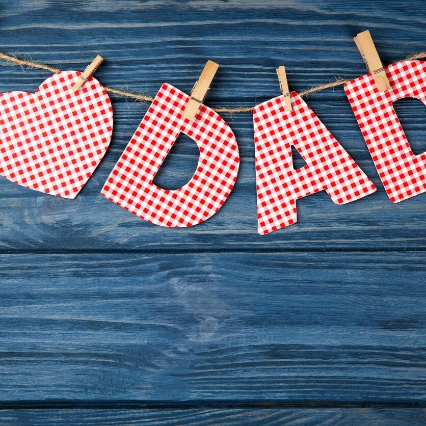 Composition with phrase I LOVE DAD for Father's Day on wooden background